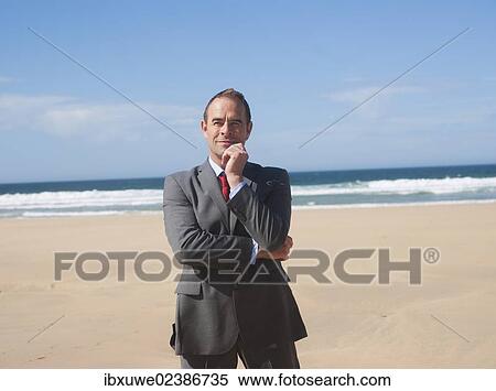 Businessman standing at the beach View Large Photo Image Stock Photography - Businessman standing at the beach. Fotosearch