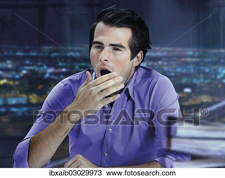 "Businessman, tired, yawning, working overtime, night" View Large Photo Image Stock Image - "Businessman, tired, yawning, working overtime, night". Fotosearch