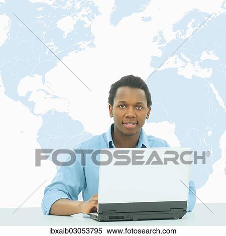 "Businessman, using a laptop in front of a world map" View Large Photo Image Stock Photography - "Businessman, using a laptop in front of a world map". Fotosearch