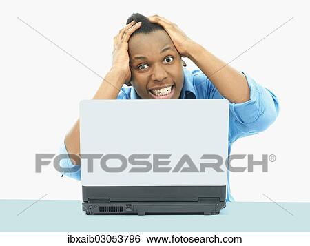 "Businessman, using a laptop, looking desperate" View Large Photo Image Stock Photograph - "Businessman, using a laptop, looking desperate". Fotosearch