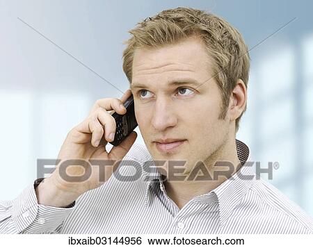 "Businessman using a mobile phone, concentrating" View Large Photo Image Stock Photograph - "Businessman using a mobile phone, concentrating". Fotosearch