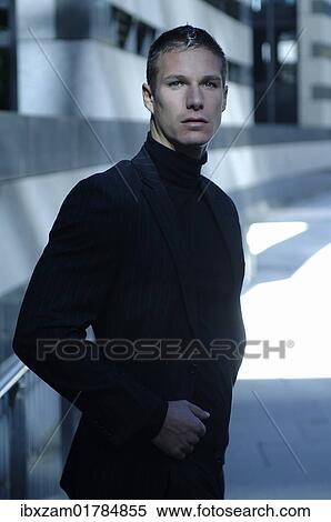 "Businessman wearing a dark suit, standing in front of a modern bank building" View Large Photo Image Stock Photography - "Businessman wearing a dark suit, standing in front of a modern bank building". Fotosearch