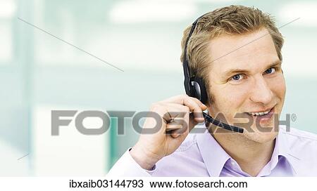 Businessman wearing a headset View Large Photo Image Stock Image - Businessman wearing a headset. Fotosearch