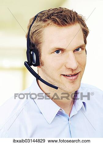 Businessman wearing a headset View Large Photo Image Stock Photo - Businessman wearing a headset. Fotosearch
