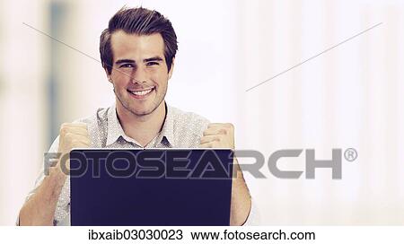 "Businessman with laptop, fists clenched, successful" View Large Photo Image Stock Image - "Businessman with laptop, fists clenched, successful". Fotosearch