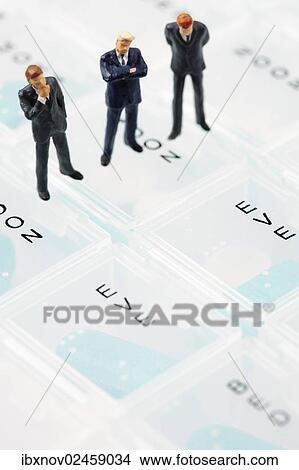 Businessmen miniature figurines on pill box View Large Photo Image Picture - Businessmen miniature figurines on pill box. Fotosearch