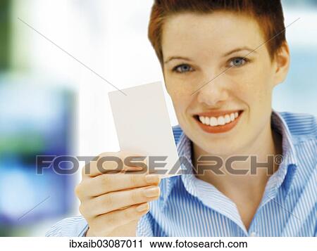 Businesswoman holding a blank business card View Large Photo Image Stock Image - Businesswoman holding a blank business card. Fotosearch