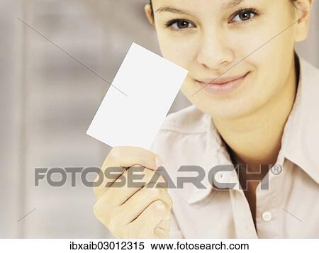 Stock Photography - Businesswoman holding a business card. Fotosearch