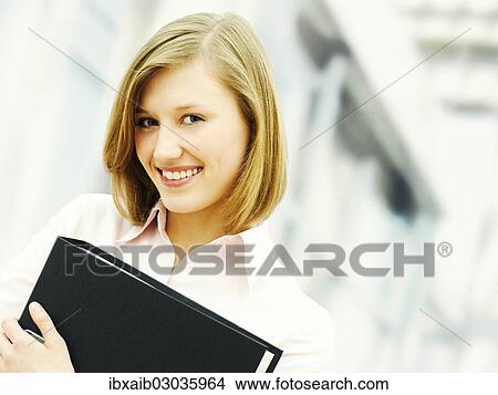 Businesswoman holding a ring binder View Large Photo Image Picture - Businesswoman holding a ring binder. Fotosearch