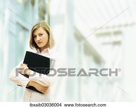Businesswoman holding a ring binder View Large Photo Image Picture - Businesswoman holding a ring binder. Fotosearch