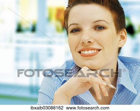 "Businesswoman in an office, smiling" View Large Photo Image Stock Image - "Businesswoman in an office, smiling". Fotosearch