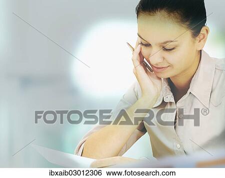 Businesswoman in an office View Large Photo Image Stock Photograph - Businesswoman in an office. Fotosearch