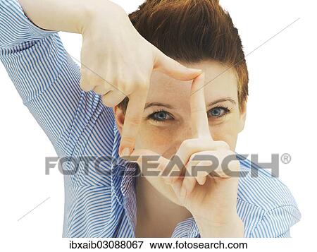 Businesswoman looking through her fingers as a frame View Large Photo Image Stock Photo - Businesswoman looking through her fingers as a frame. Fotosearch