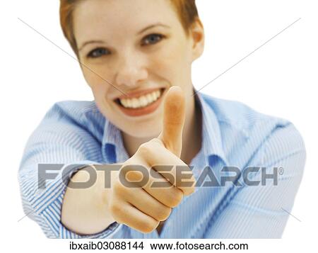Picture - Businesswoman making a thumbs up gesture. Fotosearch