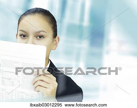 Stock Photography - Businesswoman reading a newspaper. Fotosearch