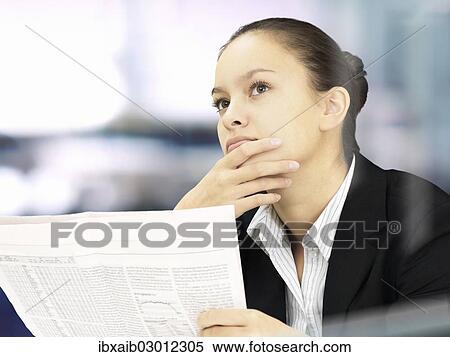 Businesswoman reading a newspaper View Large Photo Image Stock Photography - Businesswoman reading a newspaper. Fotosearch