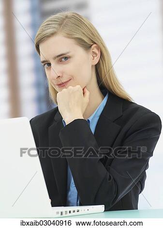 Businesswoman using a laptop View Large Photo Image Stock Photograph - Businesswoman using a laptop. Fotosearch
