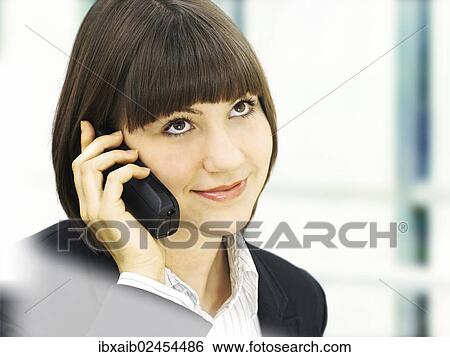 Businesswoman using a telephone View Large Photo Image Stock Photograph - Businesswoman using a telephone. Fotosearch