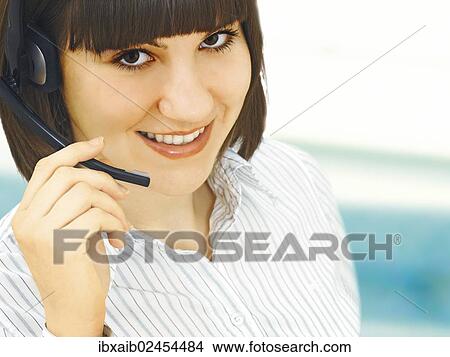 Businesswoman wearing a headset View Large Photo Image Picture - Businesswoman wearing a headset. Fotosearch