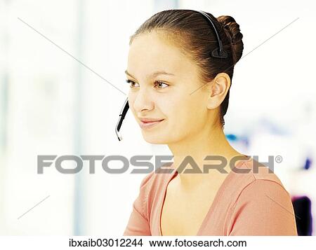 Picture - Businesswoman wearing a headset. Fotosearch