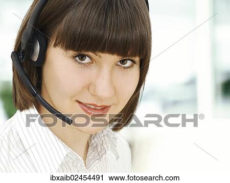 Businesswoman wearing a headset View Large Photo Image Stock Image - Businesswoman wearing a headset. Fotosearch