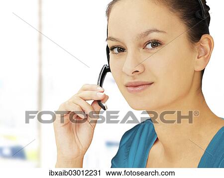 Businesswoman wearing a headset View Large Photo Image Stock Image - Businesswoman wearing a headset. Fotosearch