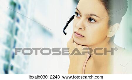 Businesswoman wearing a headset View Large Photo Image Stock Image - Businesswoman wearing a headset. Fotosearch