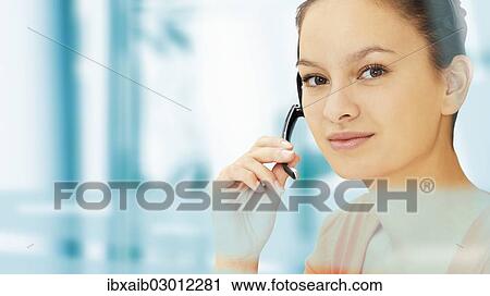 Businesswoman wearing a headset View Large Photo Image Stock Image - Businesswoman wearing a headset. Fotosearch