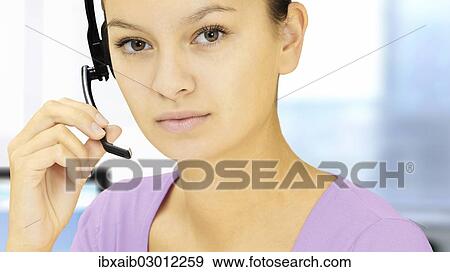 Businesswoman wearing a headset View Large Photo Image Stock Photo - Businesswoman wearing a headset. Fotosearch