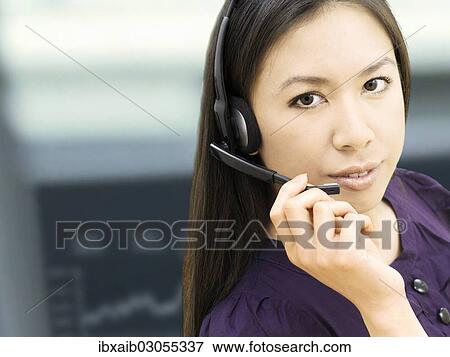 Businesswoman wearing a headset View Large Photo Image Stock Photo - Businesswoman wearing a headset. Fotosearch