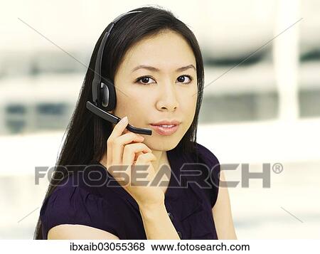 Businesswoman wearing a headset View Large Photo Image Stock Photo - Businesswoman wearing a headset. Fotosearch