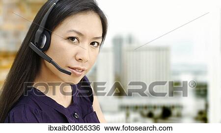 Businesswoman wearing a headset View Large Photo Image Stock Photograph - Businesswoman wearing a headset. Fotosearch
