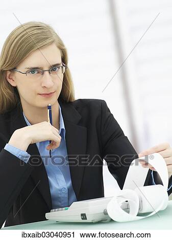 "Businesswoman wearing glasses and using a calculator, accounting" View Large Photo Image Stock Image - "Businesswoman wearing glasses and using a calculator, accounting". Fotosearch