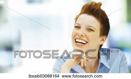 "Businesswoman with a punk hairstyle in an office, smilin" View Large Photo Image Picture - "Businesswoman with a punk hairstyle in an office, smilin". Fotosearch