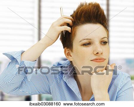 "Businesswoman with a punk hairstyle in an office, looking pensive" View Large Photo Image Stock Image - "Businesswoman with a punk hairstyle in an office, looking pensive". Fotosearch