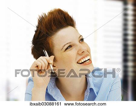 "Businesswoman with a punk hairstyle in an office, smiling" View Large Photo Image Stock Image - "Businesswoman with a punk hairstyle in an office, smiling". Fotosearch