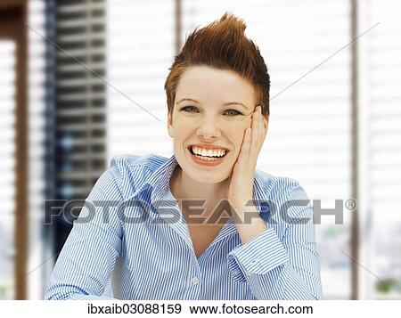 "Businesswoman with a punk hairstyle in an office, smiling" View Large Photo Image Stock Photo - "Businesswoman with a punk hairstyle in an office, smiling". Fotosearch