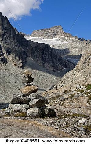 Stock Image - "Cairn in Baechlital valley in front of Gross Diamentstock Mountain and Baechli Glacier, Bernese Alps, Switzerland, Europe". Fotosearch