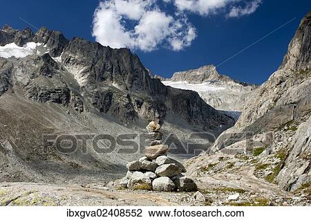 Stock Image - "Cairn in Baechlital valley in front of Gross Diamentstock Mountain and Baechli Glacier, Bernese Alps, Switzerland, Europe". Fotosearch