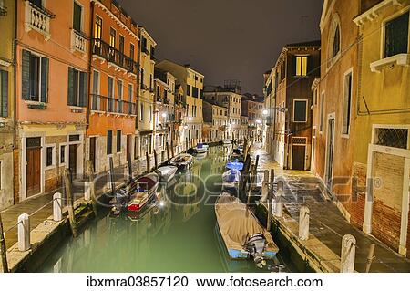 Stock Image - "Canal with boats and colourful houses at night, Venice, Veneto, Italy, Europe". Fotosearch