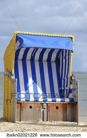 "Canopied beach chair on the North Sea coast, Wyk auf Foehr, Schleswig-Holstein, Germany, Europe" View Large Photo Image Stock Photograph - "Canopied beach chair on the North Sea coast, Wyk auf Foehr, Schleswig-Holstein, Germany, Europe". Fotosearch