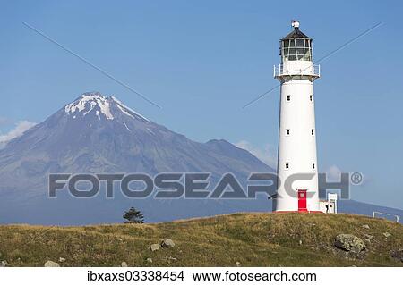 Picture - "Cape Egmont Lighthouse with Mount Taranaki, Pungarehu, Taranaki Region, New Zealand, Oceania". Fotosearch