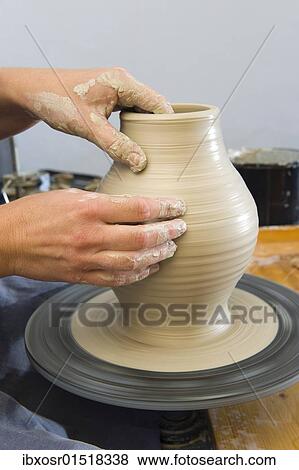 "Ceramic artist working in her workshop with a potter's wheel, turning a vase, Geisenhausen, Bavaria, Germany, Europe" View Large Photo Image Stock Photo - "Ceramic artist working in her workshop with a potter's wheel, turning a vase, Geisenhausen, Bavaria, Germany, Europe". Fotosearch