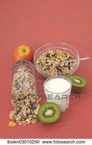 "Cereal or muesli, a glass of milk, an apple and a kiwi" View Large Photo Image Stock Image - "Cereal or muesli, a glass of milk, an apple and a kiwi". Fotosearch