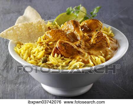 Stock Photograph - "Chicken Bhuna Indian curry, pilau rice and papadums". Fotosearch