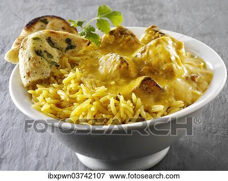 Stock Photo - "Chicken Passanda curry, pilau rice and naan bread". Fotosearch