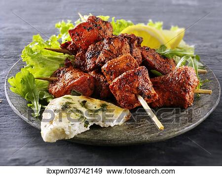 Chicken Tikka with salad and naan bread View Large Photo Image Stock Photo - Chicken Tikka with salad and naan bread. Fotosearch