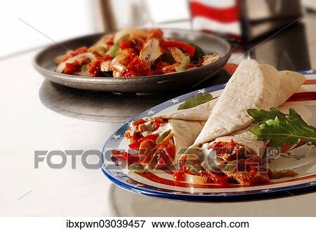 "Chicken tortillas on a plate, grilled Mexican chicken at the back" View Large Photo Image Stock Photo - "Chicken tortillas on a plate, grilled Mexican chicken at the back". Fotosearch