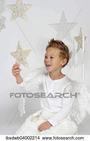 "Child, boy wearing an angel costume with stars, Christmas, festive season" View Large Photo Image Picture - "Child, boy wearing an angel costume with stars, Christmas, festive season". Fotosearch