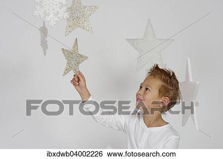 "Child, boy wearing an angel costume with stars, Christmas, festive season" View Large Photo Image Stock Photograph - "Child, boy wearing an angel costume with stars, Christmas, festive season". Fotosearch